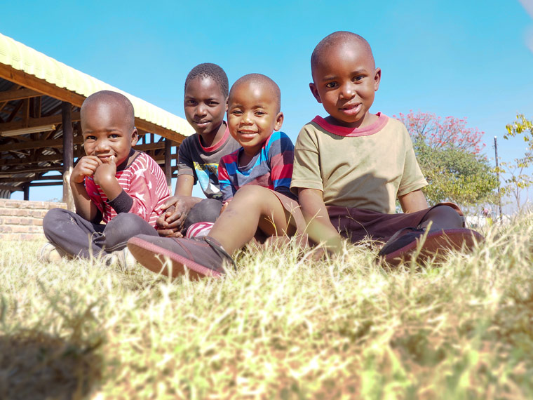 children sitting in the grass